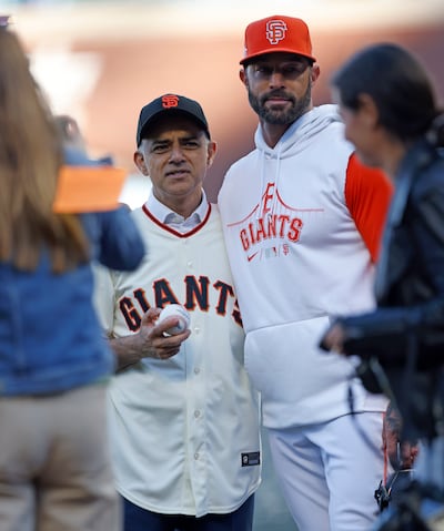 Sadiq Khan with San Francisco Giants manager Gabe Kapler after throwing the ceremonial first pitch before a Giants game in California in 2022. EPA