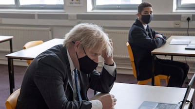 Boris Johnson sits in front of a laptop computer as he takes part in an online lesson during his visit to Sedgehill School. Johnson on Monday set out a four-step plan to ease coronavirus restrictions, expressing hope that life could get back to normal by the end of June. AFP