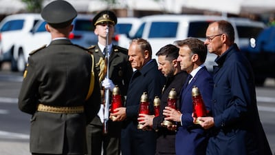 Polish Prime Minister Donald Tusk, Ukraine's President Volodymyr Zelenskyy, French President Emmanuel Macron and German Chancellor Friedrich Merz walk along a makeshift memorial for fallen Ukrainian defenders, amid Russia’s attack on Ukraine, at the Independence Square in Kyiv. Reuters
