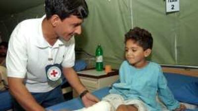 A physiotherapist helps a child at the ICRC field hospital for war wounded in Peshawar.