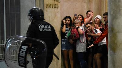 River Plate fans hide from the police during Copa Libertadores victory celebrations in Buenos Aires. AP