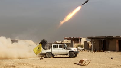 Iraqi Shiite fighters fire a rocket during a military operation against ISIS as they advance towards the centre of Baiji, about 200 kilometres north of Baghdad, on October 19, 2015.