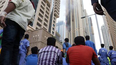 The fire, believed to have started on the 60th floor of the Sulafa Tower about 2.45pm, spread quickly in the strong wind and damaged apartments on eight floors. Pawan Singh / The National