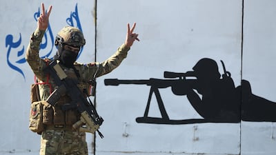 A member of Iraq's rapid response military unit takes part in celebrations at Baghdad's International Airport. AFP