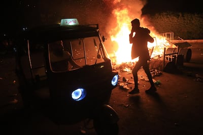 Burning tyres light up the night skies during anti-government protests in the holy city of Karbala, south of Iraq's capital Baghdad, late October 28, 2019. AFP