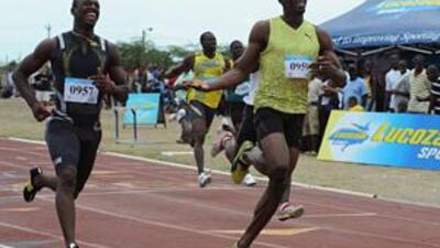 Usain Bolt, right, wins his first 100 metre race of 2009 during the GC Foster College Classic in Spanish Town, Jamaica on Saturday.