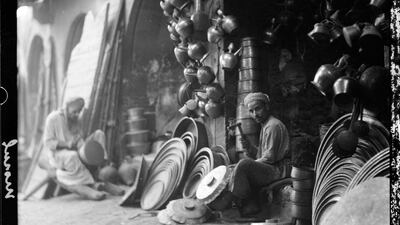 1932: A coppersmith working in the market in Mosul. AP Photo