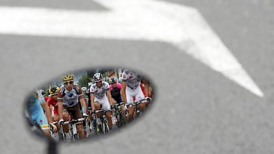 The pack of riders is reflected in a rear mirror during the 177-km fourteenth stage of the Tour de France cycling race between Grenoble and Risoul. Jean-Paul Pelissier / Reuter