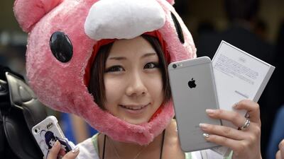 A young Japanese woman poses with her new iPhone 6. Franck Robichon / EPA