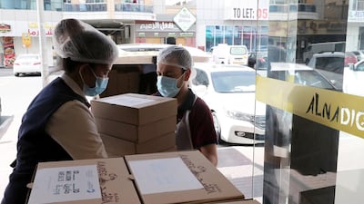 Staff at Al Nadeg restaurant in Deira, Dubai box up fresh and dried food