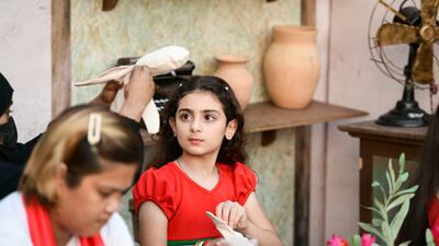 A young dollmaker practises her skills
