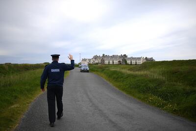 An Irish police officer stops traffic at the Doonbeg golf course for security checks. Reuters