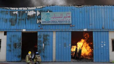 Fourteen warehouses were destroyed or damaged after a huge blaze tore through an industrial area in Sharjah on Monday. Pawan Singh / The National
