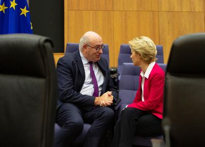 European Commission President Ursula von der Leyen, right, speaks with Phil Hogan in January. Ms von der Leyen thanked Mr Hogan for his 'tireless work'. AP