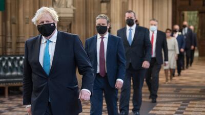 British Prime Minister Boris Johnson strides through Parliament ahead of opposition leaders on his way to listen to Queen Elizabeth II announce new legislation that will be implemented over the next year. Getty