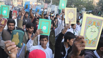 Pakistani protesters holding copies of the Quran in Lahore, Pakistan, on Saturday. AP