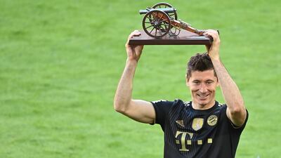 Robert Lewandowski receives the trophy for the top goal-scorer of the Bundesliga season. EPA