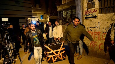 Egyptian police carry equipment to the site of the explosion. AFP