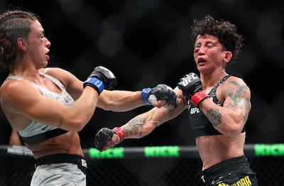 Mackenzie Dern, left, traded blows with Virna Jandiroba in 25 minutes of brutal action in the co-main event of UFC 321. Chris Whiteoak / The National