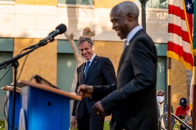 US Secretary of State Antony Blinken laughs as US Ambassador to Senegal Tulinabo Mushingi dances to music at the US Embassy in Dakar, on November 20, 2021, as part of Blinken's 5-day trip to Kenya, Nigeria, and Senegal. Pool / AFP
