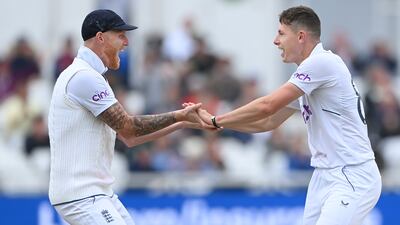 England bowler Matthew Potts, right, celebrates with captain Ben Stokes after taking the wicket of Henry Nicholls for three. Getty