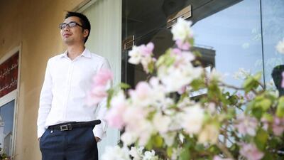 Sales agent Hai Rong Xiao of Atomic Properties in International City is kept busy with inquiries from Chinese investors, some of whom fly in with cash to snap up apartments in the city. Lee Hoagland / The National