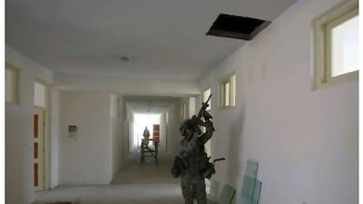 A US soldier inspects a school that is under construction near Kabul. The US has wasted billions on the wars in Afghanistan and Iraq. Joel Saget / AFP