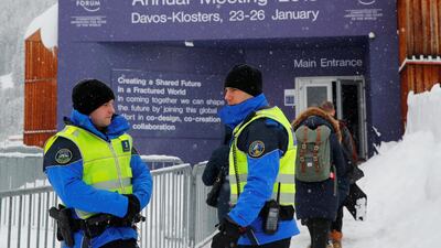 Police officers stand guard in front of the main entrance ahead of the World Economic Forum (WEF) annual meeting in the Swiss Alps resort of Davos. Denis Balibouse / Reuters