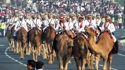 Qatari Heritage Police ride camels.