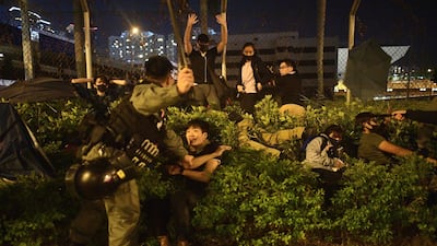 Police detain protesters and students after they tried to flee outside the Hong Kong Polytechnic University. AFP
