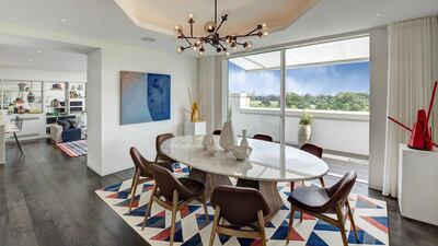 The dining area with views out to Hyde Park. Courtesy Berkshire Hathaway HomeServices London
