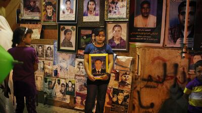 Kulud Sahati, 10, holds a picture of her brother Hosen Sahati, killed in Rajma by Gadhafi's loyalists, as people celebrate what they believe is the nearly end of the military conflict against Gadhafi's regime at the rebel-held town of Benghazi, Libya, early Tuesday, Aug. 23, 2011. World leaders said Monday the end is near for Moammar Gadhafi's regime and began looking at Libya's future without the man who has held power there for 42 years. (AP Photo/Alexandre Meneghini)