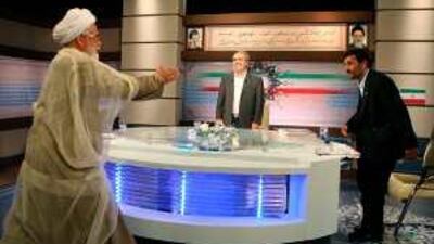 Mahdi Karrubi, the former Iranian parliament speaker and reformist presidential candidate, walks towards Mahmoud Ahmadinejad, the Iranian president, to shake hands before their live debate on state TV in Tehran on Saturday.