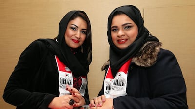 Emirati students Fatima Al Dhaheri, left, and Mona bin Hussain at the National Day party in London. Stephen Lock for The National