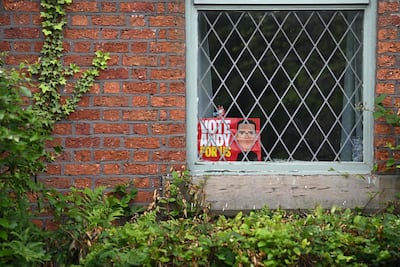A poster for Labour candidate Andy Burnham in the window of a home in Bryn, west of Manchester, ahead of the Makerfield by-election. AFP