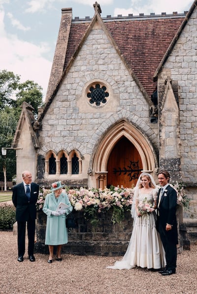 Britain's Queen Elizabeth II and Prince Philip stand alongside Princess Beatrice and Edoardo Mapelli Mozzi outside The Royal Chapel of All Saints at Royal Lodge, Windsor, England, after their wedding on Saturday July 18, 2020. AP Photo