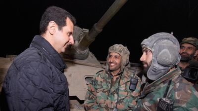 A file photo of Syrian president Bashar Al Assad meeting troops during a visit to eastern Damasus district of Jobar on December 31, 2014. Mr Al Assad's forces are facing increased pressure as ISIL presses closer to the regime-held military airbase outside Deir Ezzor. AFP Photo / Handout / SANA
