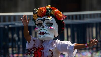 A woman with a Catrina mask attends the Day of the Dead parade at Zocalo Square in Mexico City. AFP