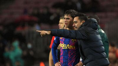 Barcelona's Spanish coach Xavi gives instructions to midfielder Gavi. AFP
