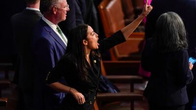 Representative Alexandria Ocasio-Cortez gestures to the Clerk of the House that there is one more Democratic vote to be cast during the roll call vote on the motion to adjourn. AP