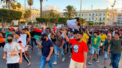 Libyans chant slogans during a demonstration due to poor public services at the Martyrs' Square at the centre of the GNA-held Libyan capital Tripoli. AFP