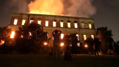 People watch as a fire burns at the National Museum of Brazil in Rio de Janeiro, Brazil two years ago. Reuters