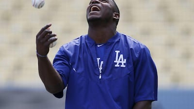 Yasiel Puig of the Los Angeles Dodgers tosses a ball in the air during practice on Tuesday ahead of the MLB play-offs. Danny Moloshok / AP / October 6, 2015