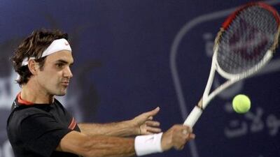 oger Federer returns the ball to Andy Murray during the final in Dubai.