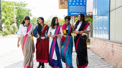 Young Indian women are draping and styling saris in myriad ways, from pairing them with T-shirts and trainers to holding the pallu, or loose end of the sari, in place with a belt. Photo: Six Yards Plus