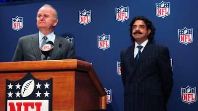New Jacksonville Jaguars owner Shahid Khan, right, stands by as team founder Wayne Weaver speaks at a news conference.
