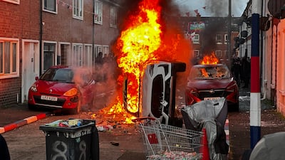 Vehicles set on fire by protesters in Belfast. PA