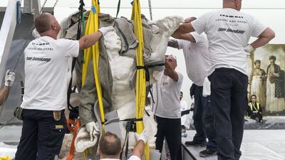 The sculpture is carefully lifted in separate pieces using pulleys. Christopher Pike / The National