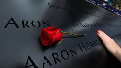 September 11, 2011. A woman touches the engraved names on the North Pool during ceremonies marking the 10th anniversary of the 9/11 attacks on the World Trade Center in New York. Jim Young / Reuters