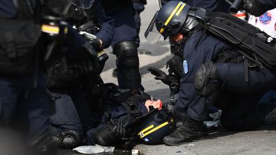 A member of the French anti-riot police CRS receives medical attention after being injured during clashes with demonstrators during a May Day rally in Paris. AFP